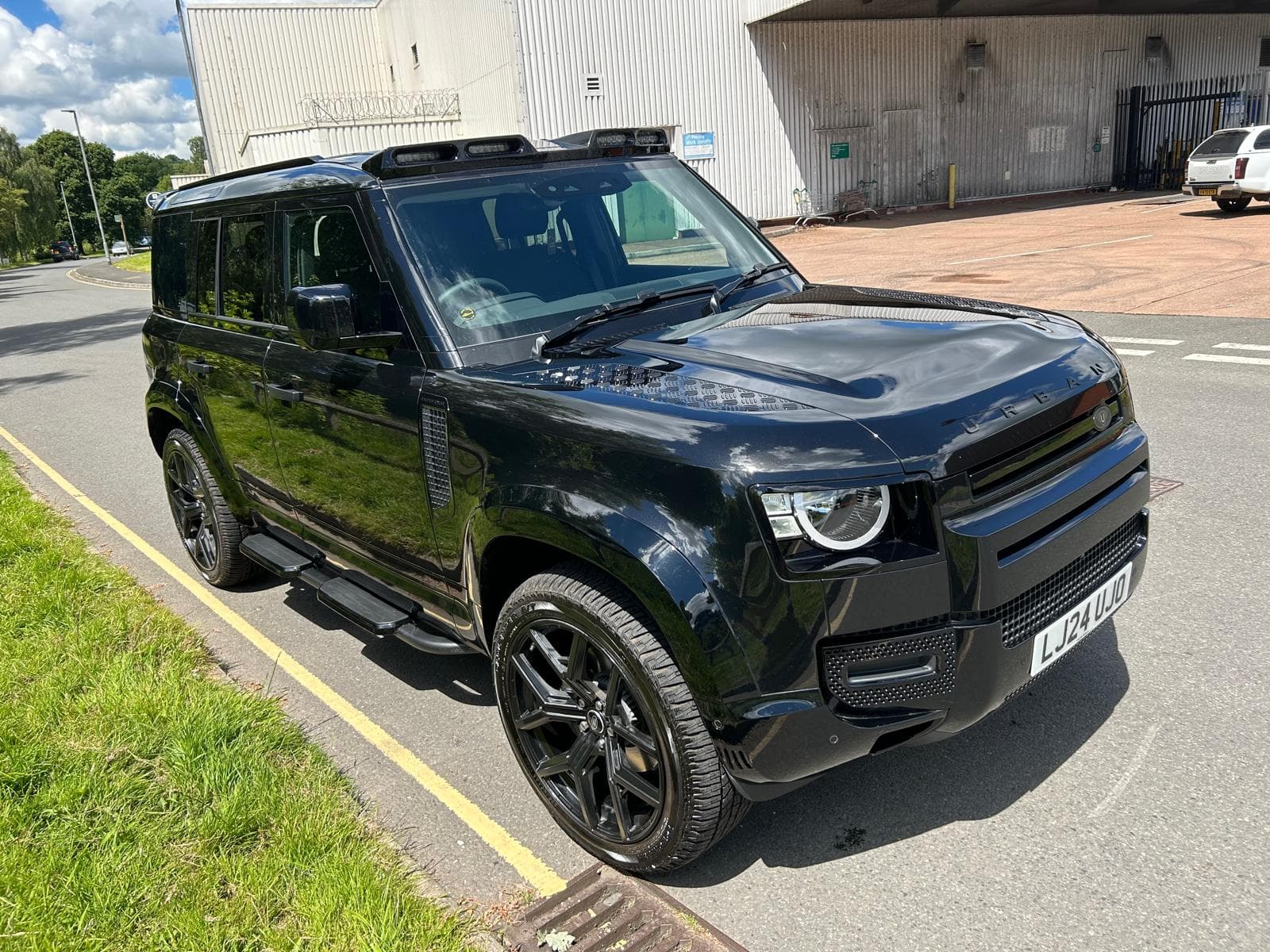 Black Land Rover Defender side after valet