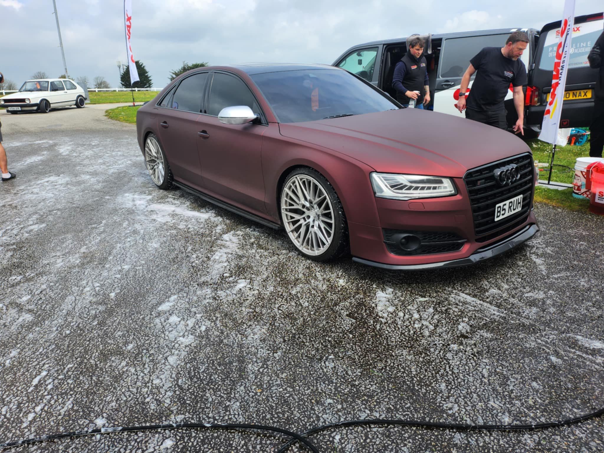 Matte red Audi S8 being washed at event
