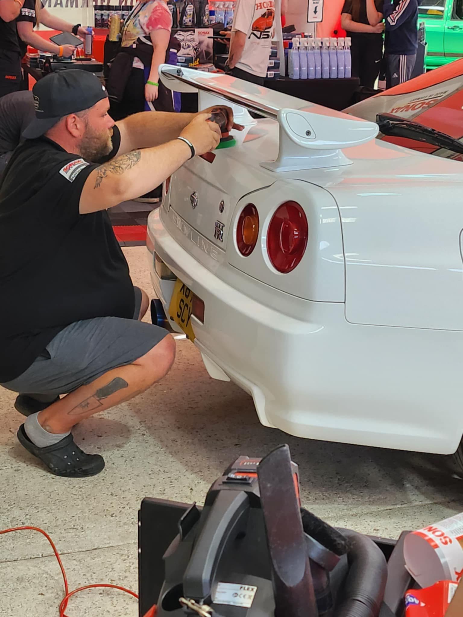Detailing work on Nissan R34 at show